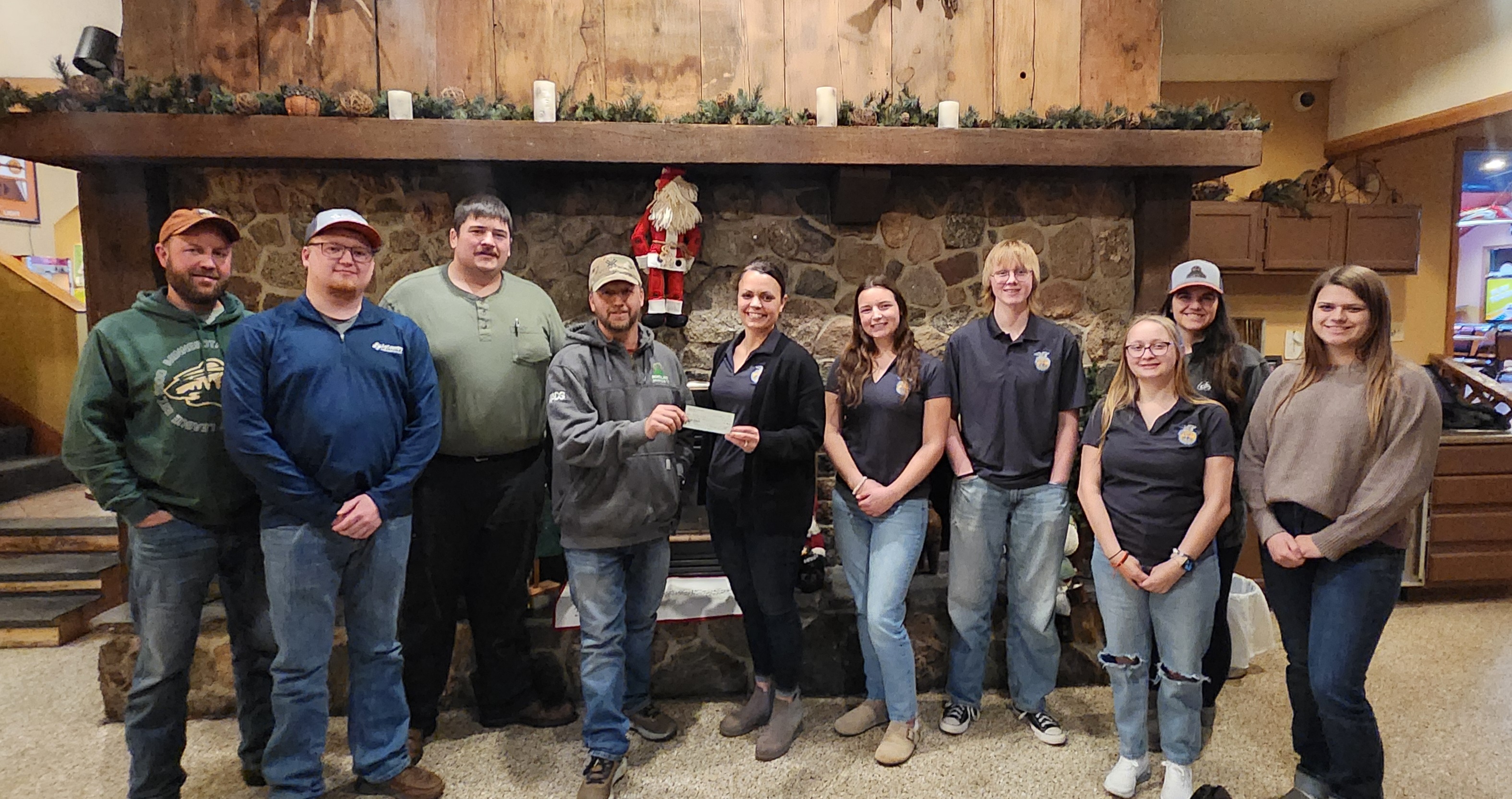 group of Farm Bureau members with FFA members and donation check