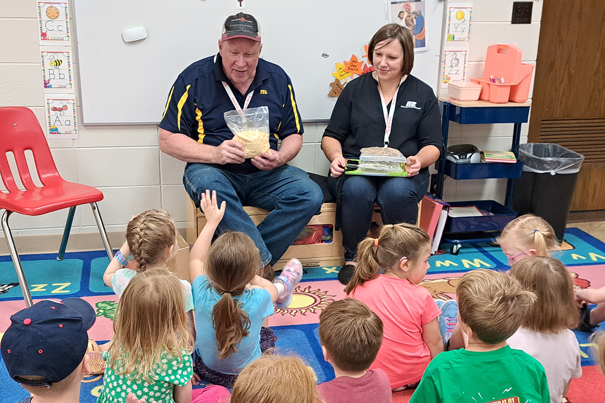 two members speaking to elementary school class