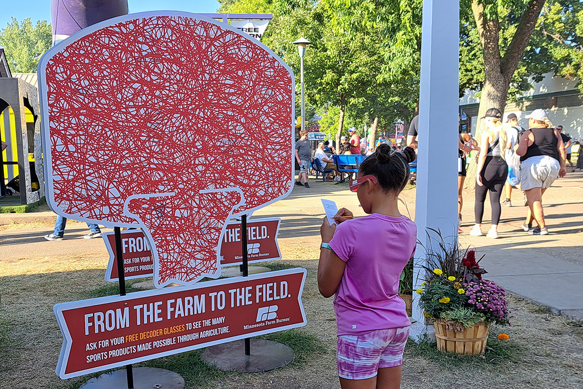 girl reading informative sign about agriculture